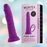 A purple silicone dildo with realistic textures is displayed beside its packaging. The box, labeled "Femme Funn Wireless Turbo Shaft - Purple" by Femme Funn, highlights features like premium quality liquid silicone, 8 vibration modes, 360-degree motion, turbo mode, and wireless remote control.